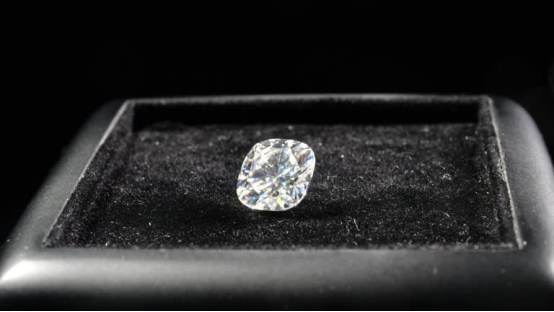 0.38 carat cushion-cut lab grown diamond resting on a black velvet display tray.